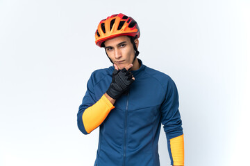 Fototapeta premium Young cyclist man isolated on background thinking