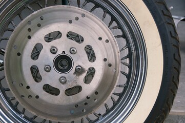 motorcycle front wheel with tyre and disk brakes , background of vintage wheel motorcycle disc...