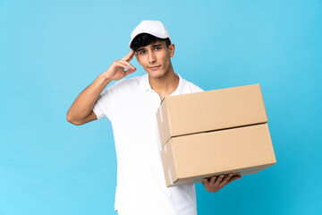 Delivery Argentinian man isolated on blue background having doubts and thinking