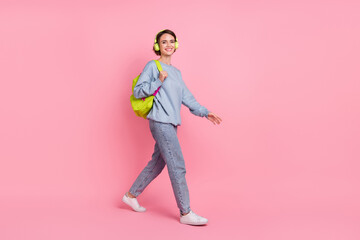 Full body photo of cute millennial lady go wear pullover jeans footwear headphones bag isolated on...