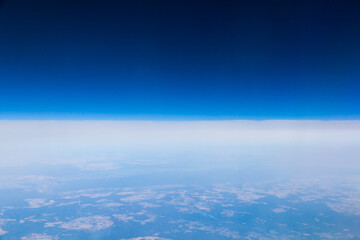 View from the plane at an altitude of 10,000 meters. Land from the height of a flying plane.