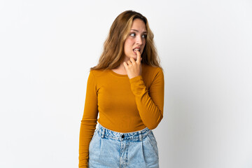 Young blonde woman isolated on blue background nervous and scared