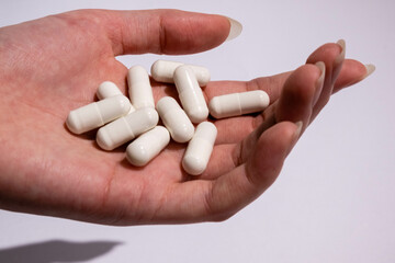 Hand with medical pills isolated. Creative close up pharmacy or health care concept. Medical treatment for disease flu virus.