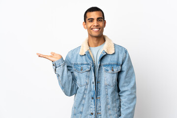 African American man over isolated white background holding copyspace imaginary on the palm to...