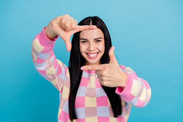 Fototapeta na wymiar Photo of excited funky lady dressed print pullover showing photo gesture isolated blue color background