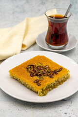 Pistachio kadayif dessert on stone background. Traditional Turkish cuisine flavor. close up