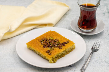 Pistachio kadayif dessert on stone background. Traditional Turkish cuisine flavor. close up