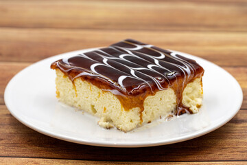 Caramel trilece dessert on wooden background. Traditional Turkish cuisine flavor. close up