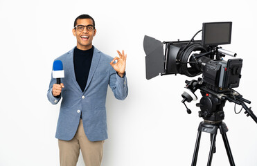 Reporter African American man holding a microphone and reporting news over isolated white background showing ok sign with two hands