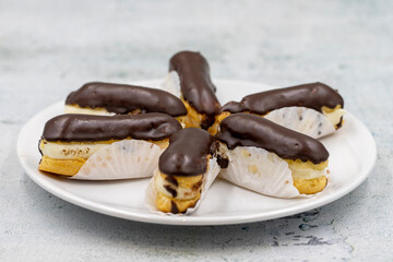 Chocolate eclair cake on stone background. Traditional french dessert. Pastry products. close up
