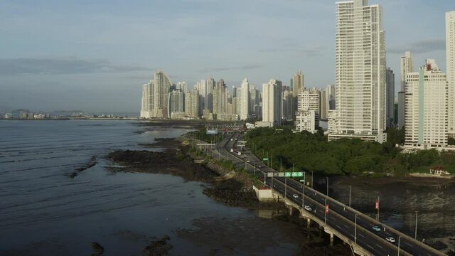 Aerial view of Panama City in Central America on a cloudy day tracking wide shot.