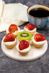 Delicious tiny tartlets on a dark background. close up
