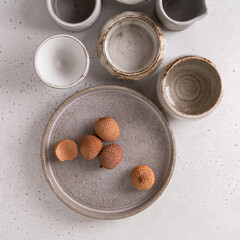 Handmade ceramic tableware, empty craft ceramic on a light background. Clay plates and cups