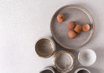 Handmade ceramic tableware, empty craft ceramic on a light background. Clay plates and cups