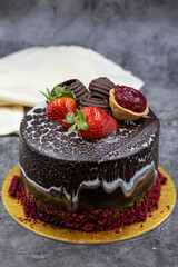 Celebratory chocolate cake on a dark background. Pastry products. close up