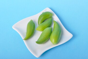 Achocha in a saucer on a blue background