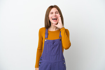 Young English woman isolated on white background shouting with mouth wide open