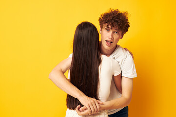cute young couple stand hugging each other in white T-shirts isolated background unaltered