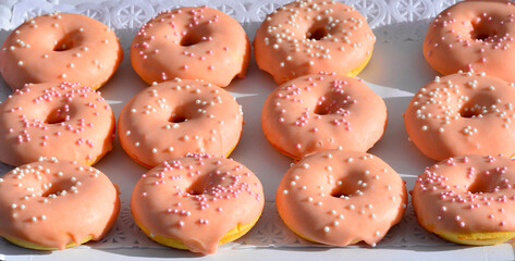donuts covered in strawberry and filled with chocolat