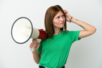 Young English woman isolated on white background holding a megaphone and having doubts
