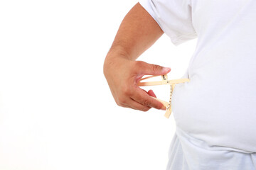 Fat man holding a caliper to measure the amount of fat in his stomach Used to measure the thickness...