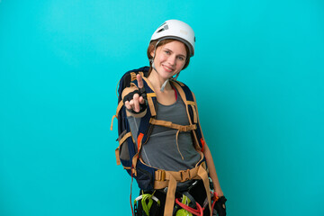 Young English rock climber woman isolated on blue background showing and lifting a finger