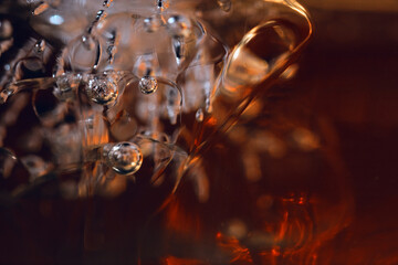 Whisky and ice in glass, close up background, selective focus. Ultra macro photography.