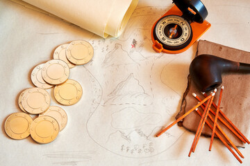 Treasure map, gold coins, compass, smoking accessories, old papers on the desk. Adventure sailing and table in the ship cabin