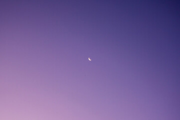 Crescent moon in purple sky