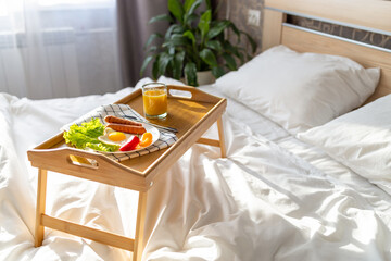 Breakfast on a tray in bed. Morning. Fried eggs in the shape of a heart with vegetables.