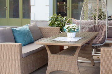 Street cafe. A typical street view with a table and sofas in front of a cafe in Georgia. Architecture and sights of Tbilisi