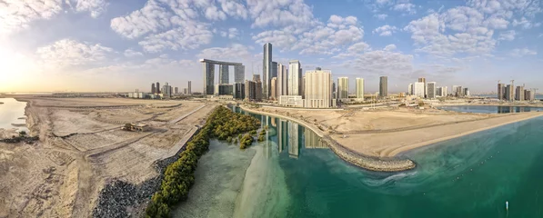 Gordijnen Aerial view on developing part of Al Reem island in Abu Dhabi on a cloudy day © Freelancer