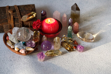 Set crystal gemstones, candle, witch book on table. minerals for Magic Crystal Ritual, Witchcraft,...