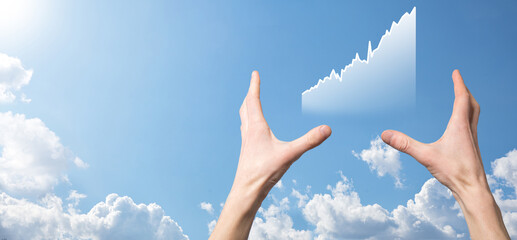 Business man holding tablet and showing holographic graphs and stock market statistics gain profits. Concept of growth planning and business strategy. Display of good economy form digital screen.