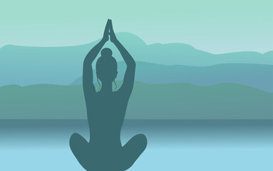 Silhouette of a woman doing yoga in the lotus pose against a background of mountains and sunset. The concept of meditation.