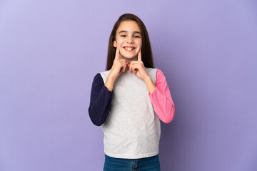 Little girl isolated on purple background smiling with a happy and pleasant expression