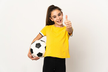 Little football player girl isolated on white background with thumbs up because something good has happened