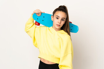 Little girl isolated on white background with a skate © luismolinero