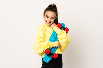 Little girl isolated on white background with a skate with happy expression