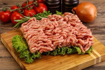 Raw pork minced meat over board