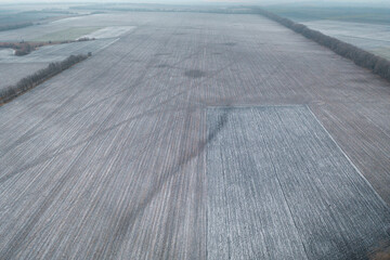 Topographic shot of agricultural land plots for Farming. Agro land for agribusiness. Topographic shot of winter field. Empty field is arable land: drone aerial view.