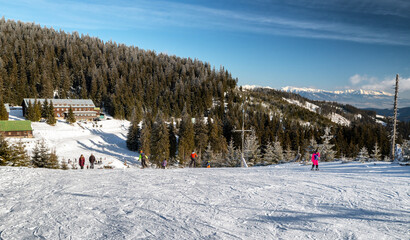 Skiers on slope and ski-lift in resort Smrekovica at Slovakia