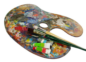 Art palette with tubes of paints and brushes.Isolated on white.Copy space.