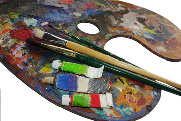 Art palette with tubes of paints and brushes.Isolated on white.Copy space.