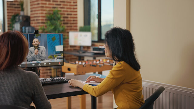 HR Workers Attending Video Call Conference With Candidate At Online Job Interview. Business Women Meeting With Man On Remote Teleconference To Talk About Hiring Contract And Employment