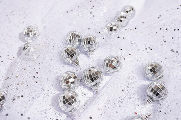 shiny silver background with disco balls and shiny fabric with sequins