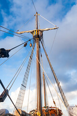 Mast with ropes and ladder on an old wooden ship, bottom view.