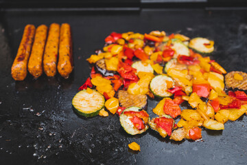 vegan barbecue with grilled vegetables plant-based sausages and corn on the cob, healthy plant-based food
