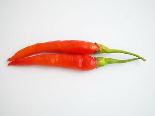 Red peppers on a white background. top view photo, blurred.