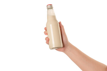 Hand holding a bottle of soy milk on white background.